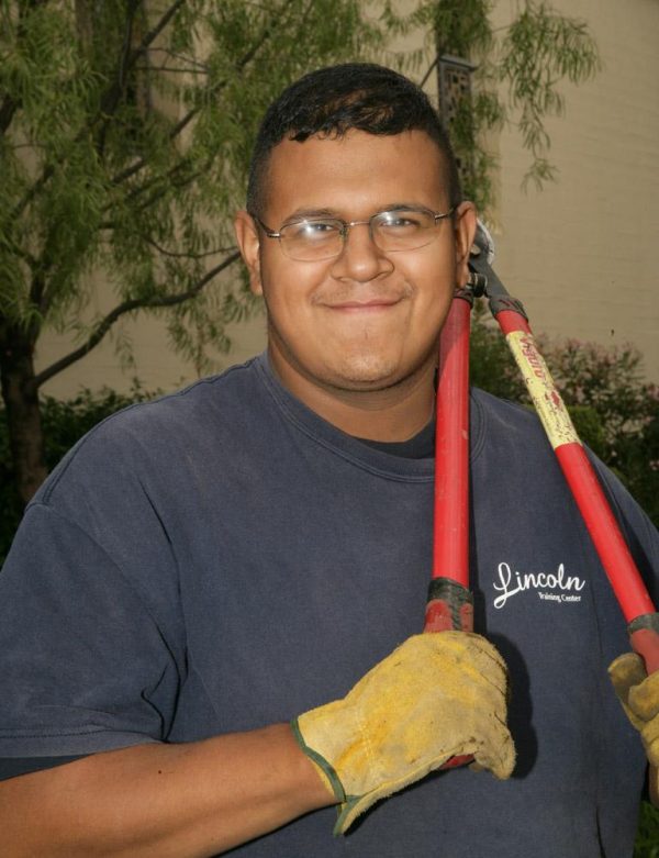 photo of a client holding a gardening tool